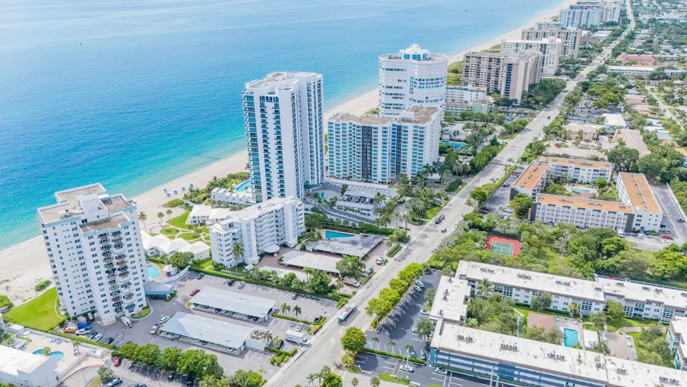 Aerial view of oceanfront condominium towers along a South Florida beach