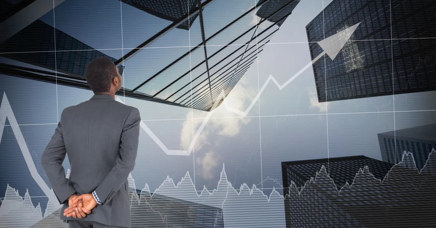 A property owner looks up at office towers, with a market chart overlaid